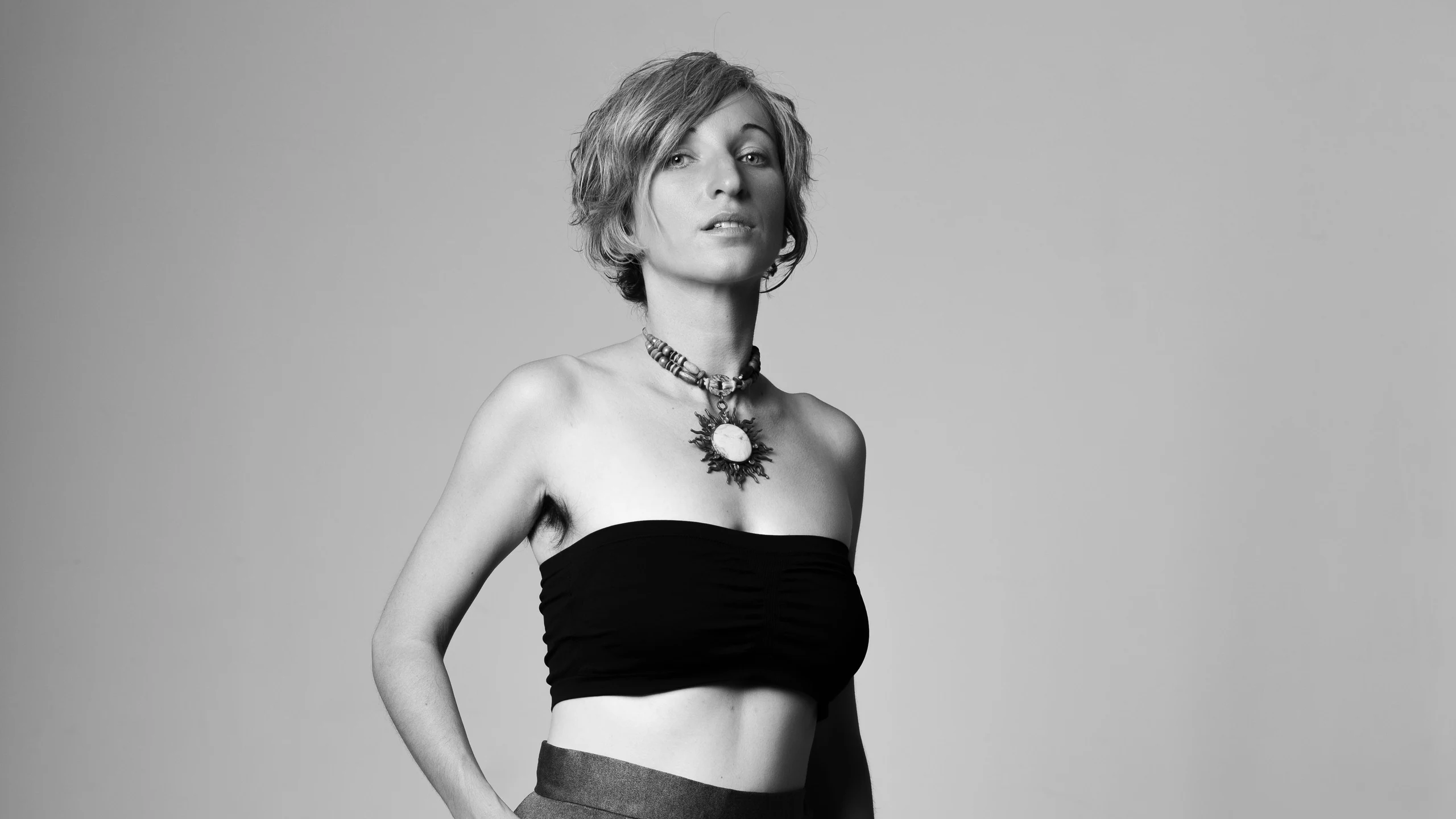 ZOE from Earth in black and white, hands on hips, looking into the lens